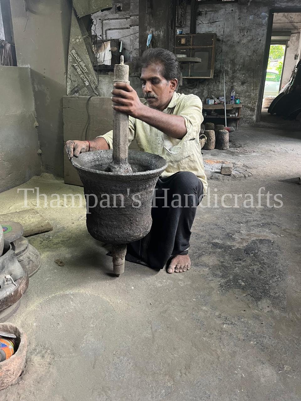 An artisan hand-building the clay core that forms the inner shape of a church bell